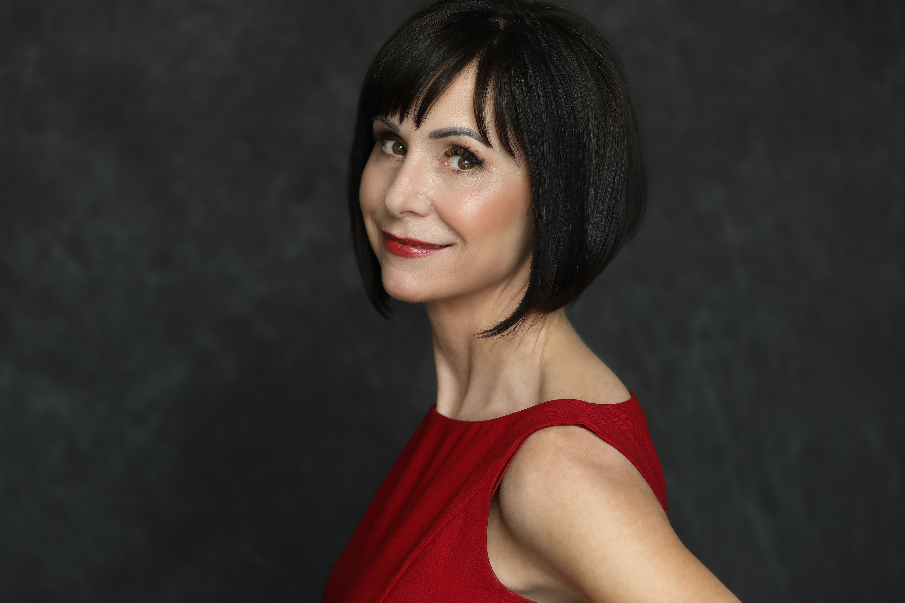 Headshot of Susan Egan wearing a red dress