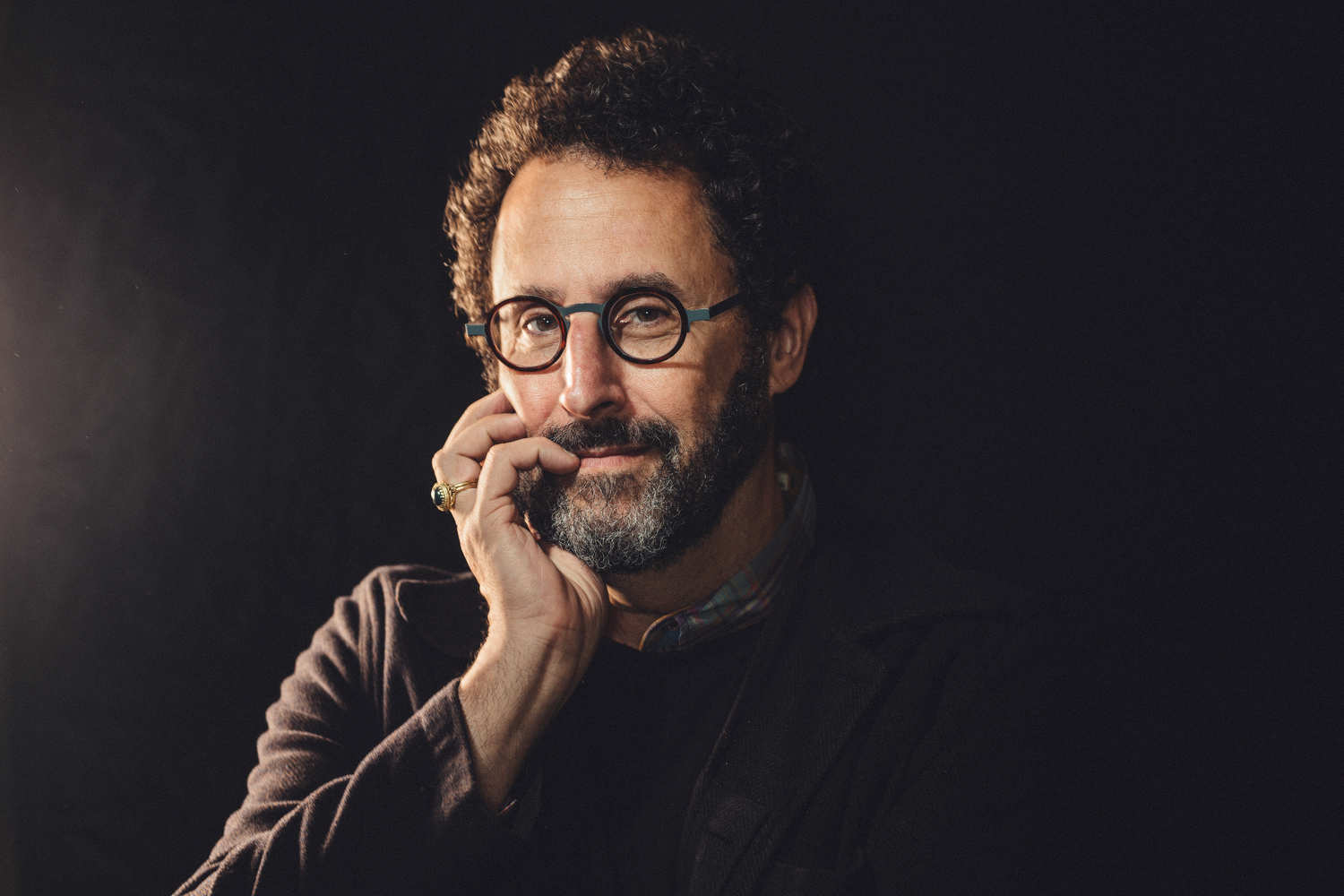 Tony Kushner sitting with his hand on his face