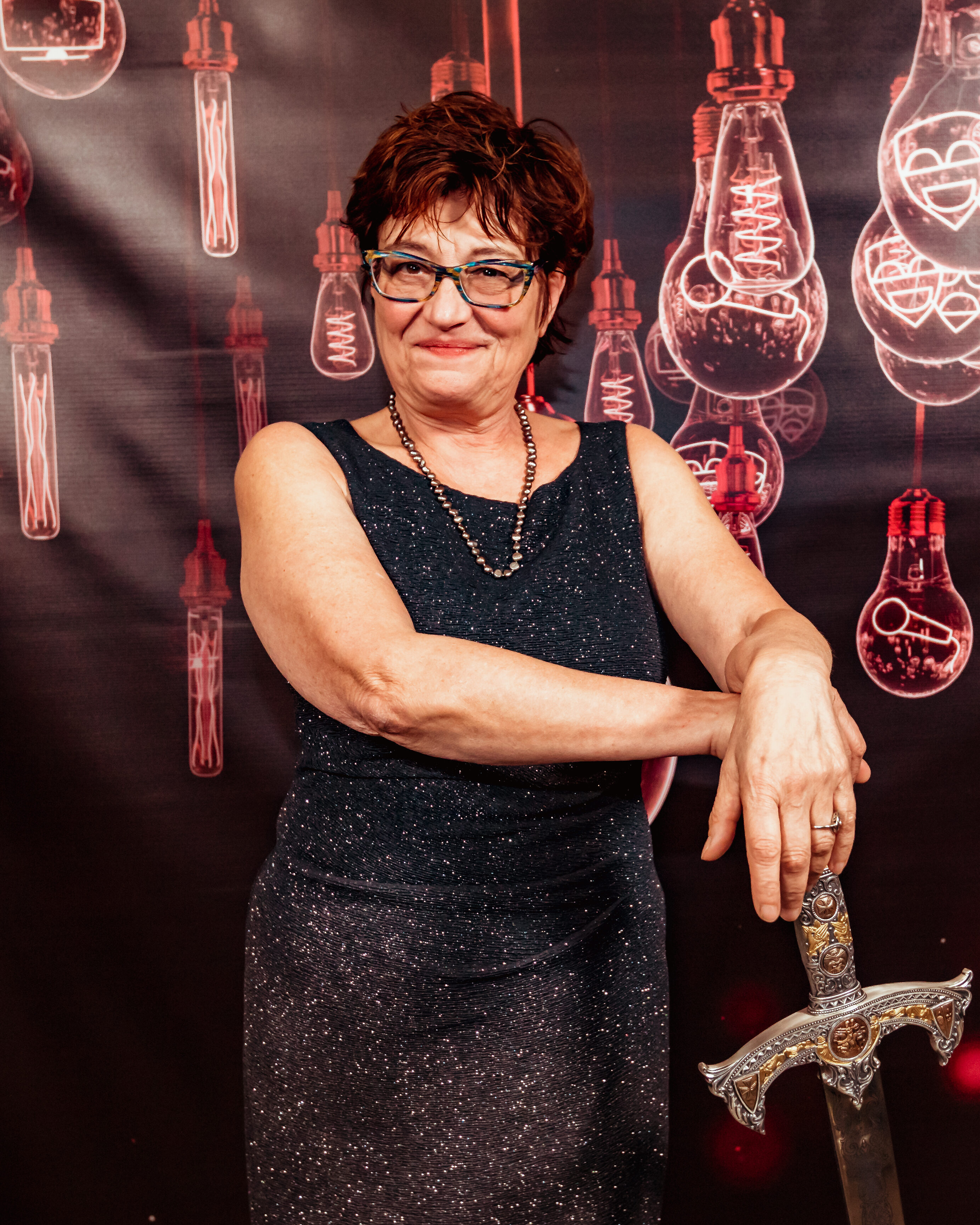 Wendall Harrington on the red carpet for the Knights of Illumination, leaning on a sword