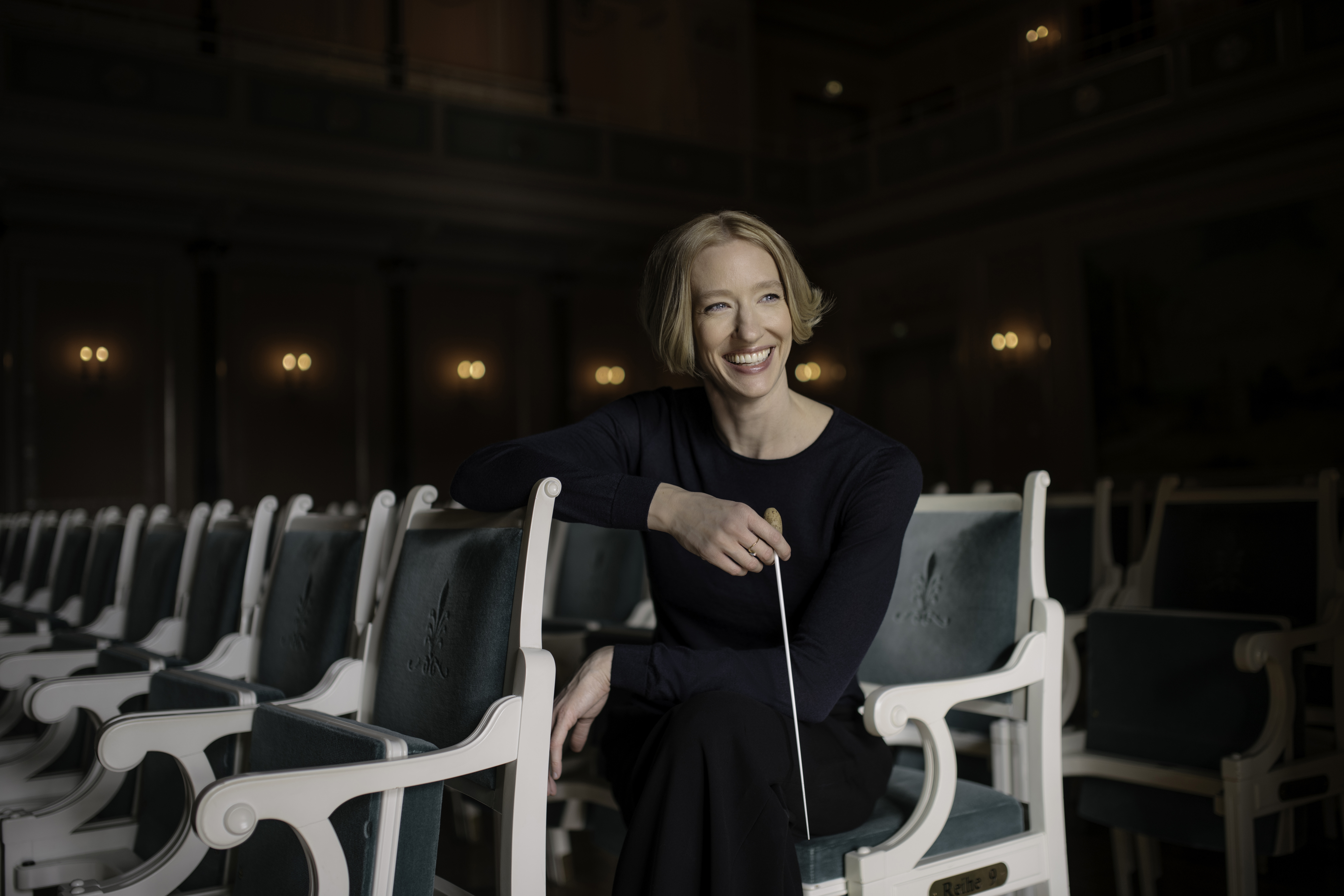 Joana Mallwitz sitting with baton