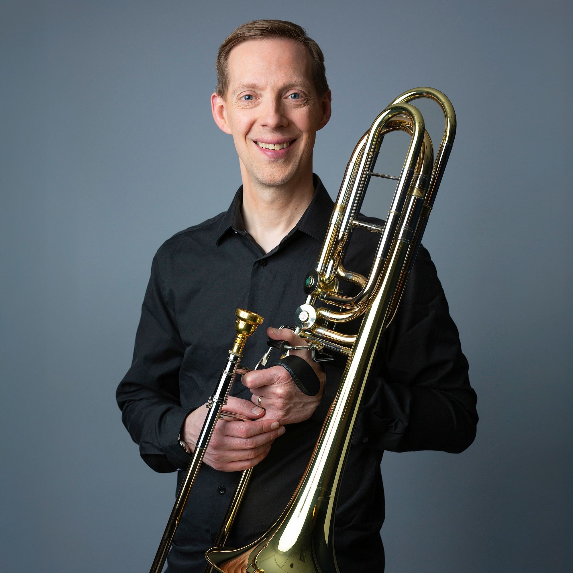 James Markey headshot with bass trombone