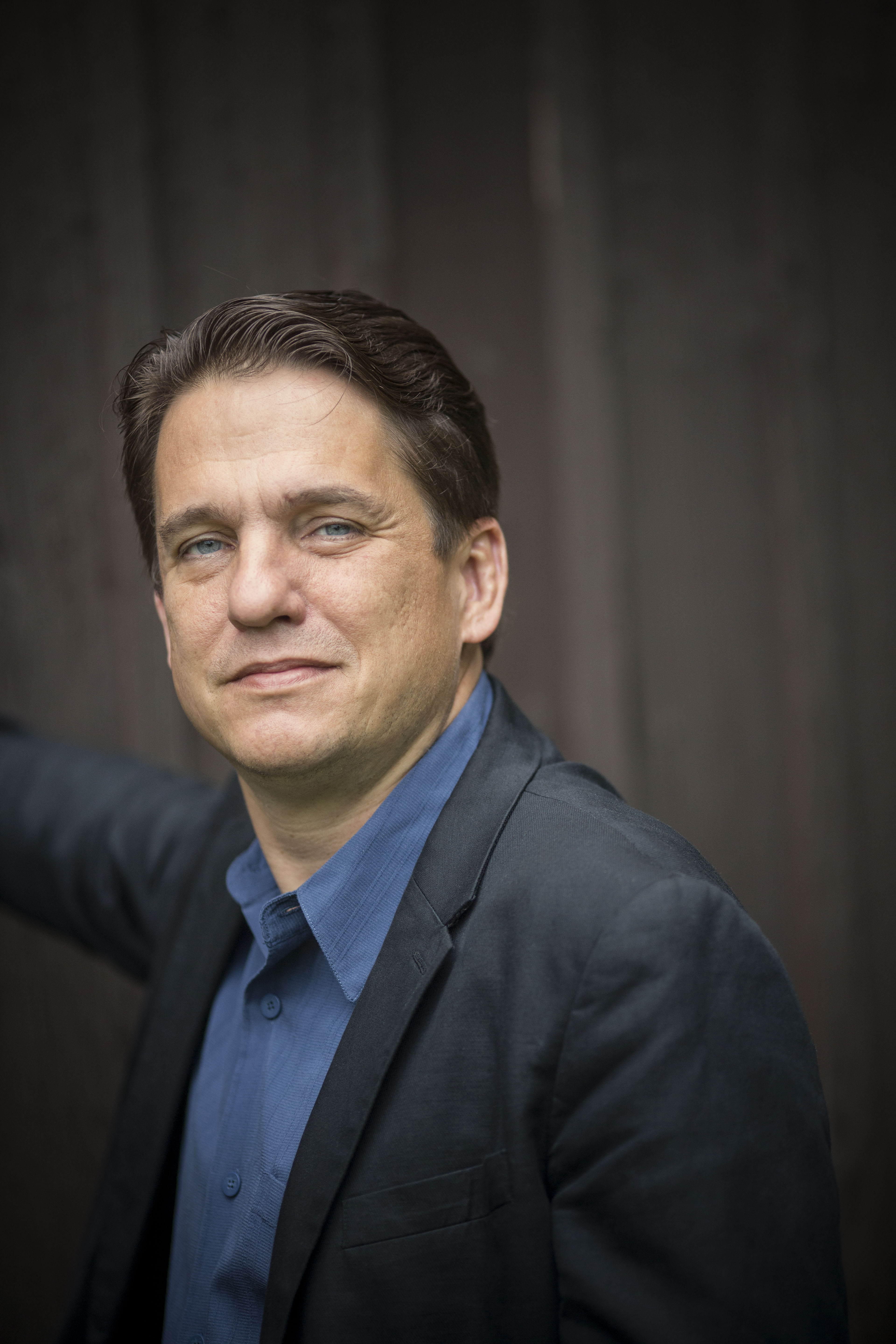 portrait of Keith Lockhart wearing a blue shirt with a blue-grey jacket