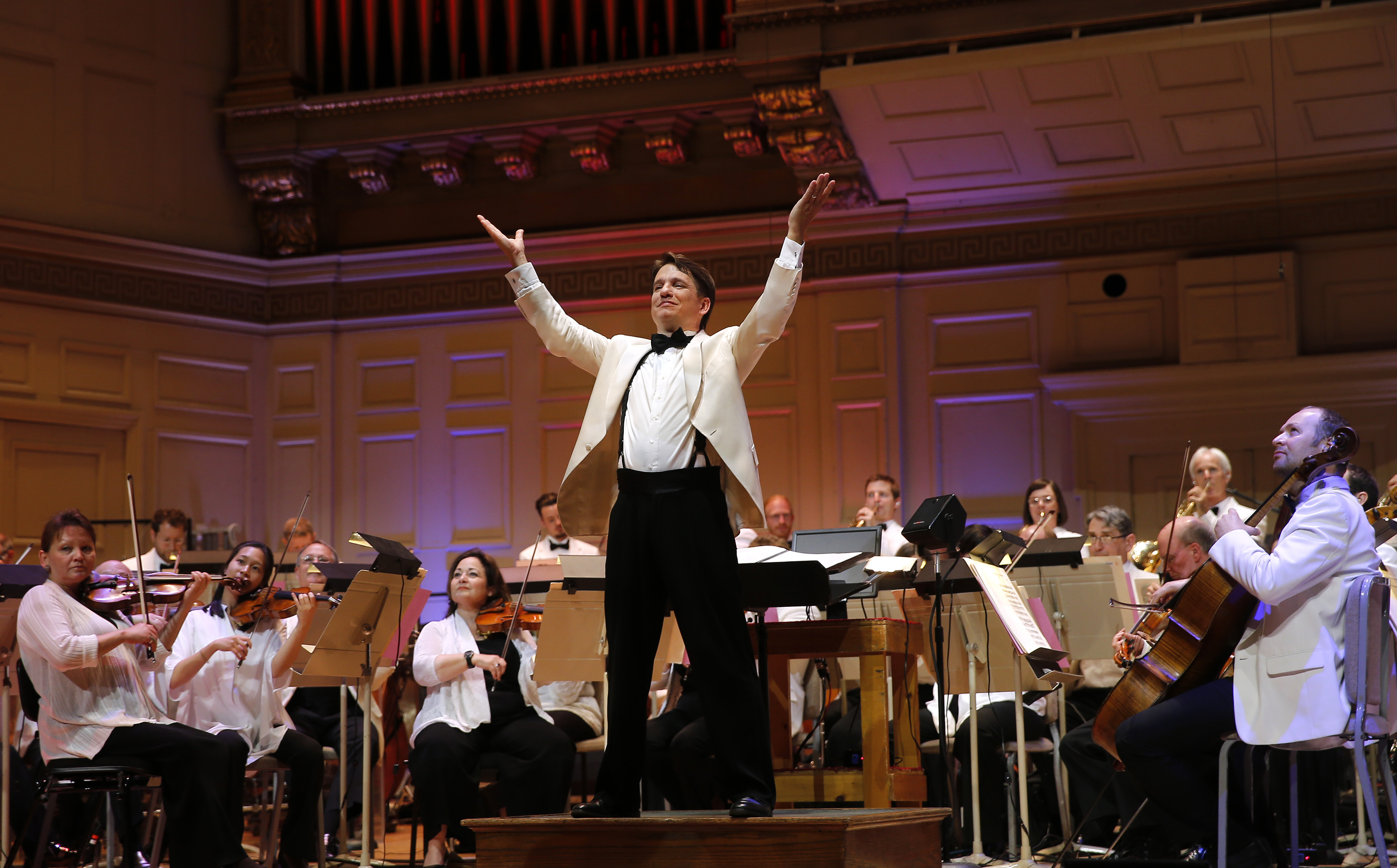 Boston Pops Conductor Keith Lockhart on stage at Symphony Hall taking bow with the orchestrea