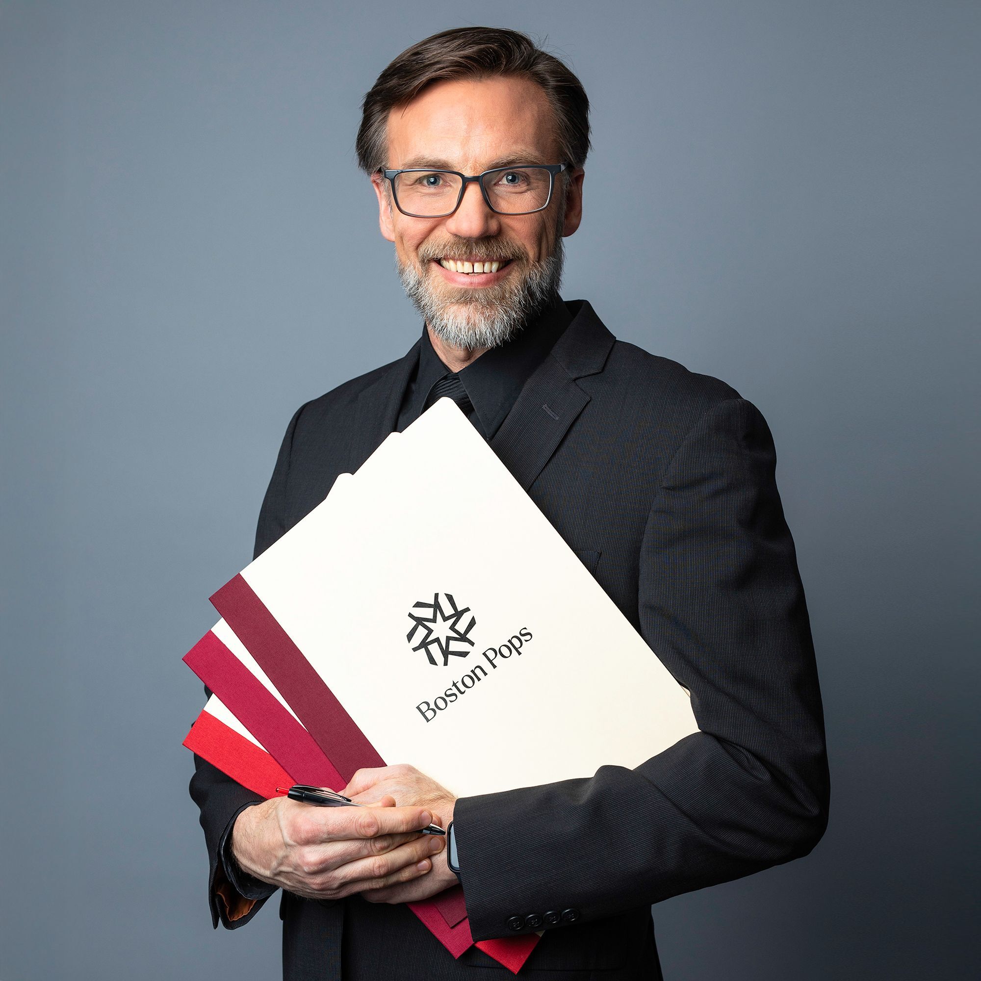 Mark Fabulich headshot holding music scores