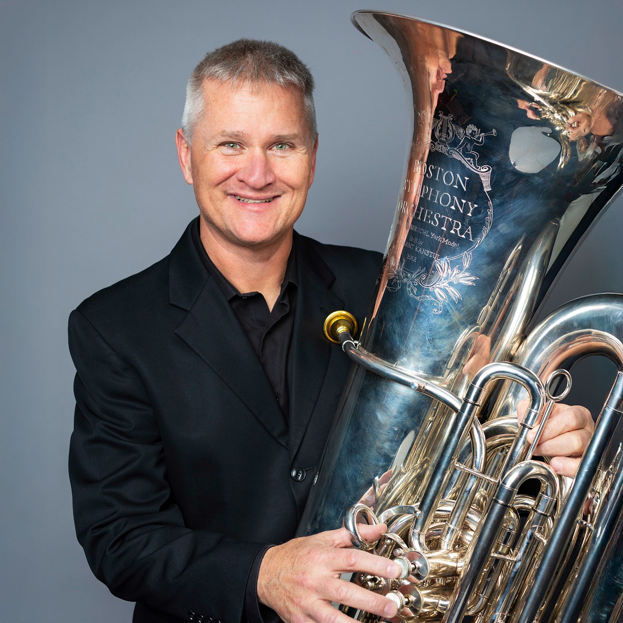 Mike Roylance headshot with tuba