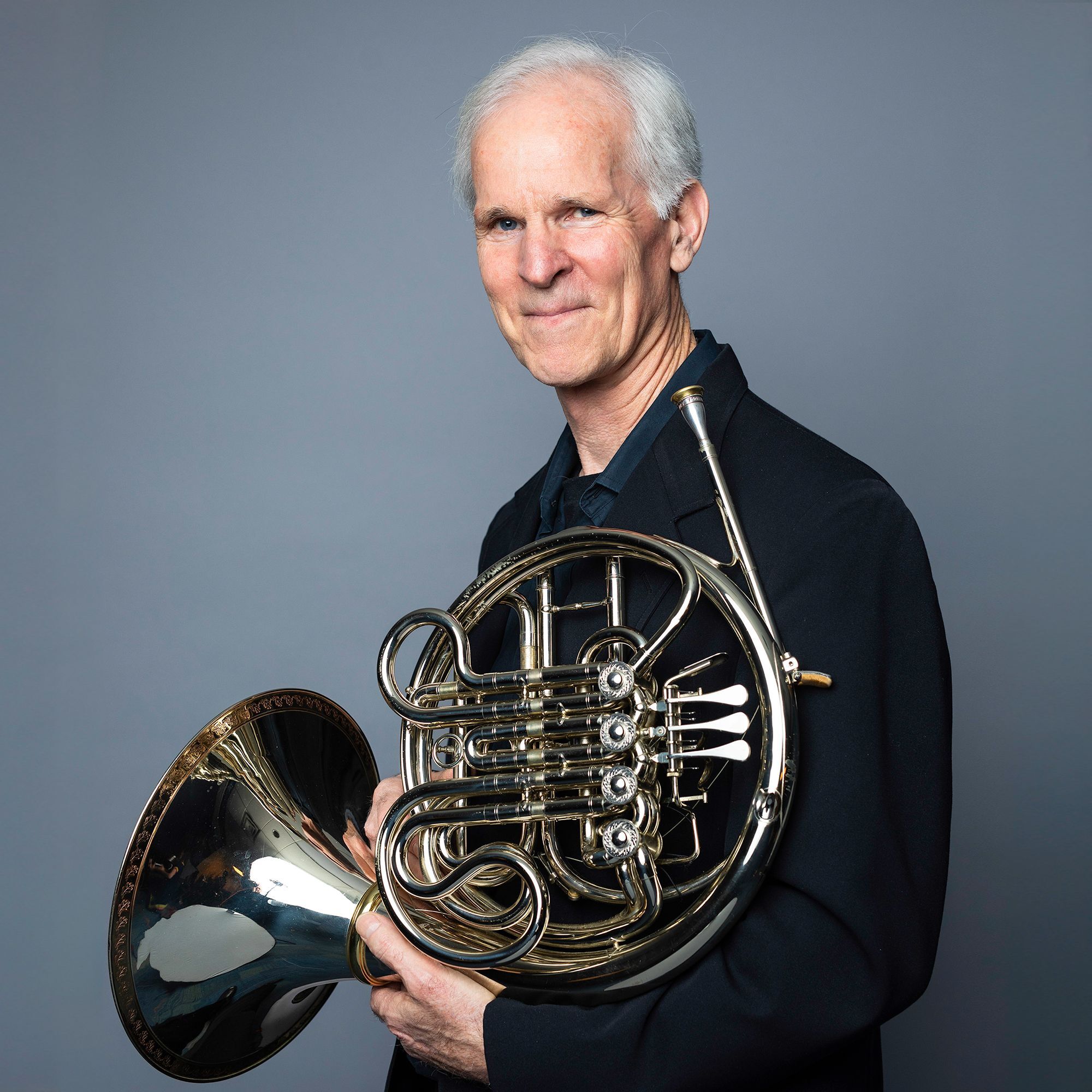 Richard Sebring headshot with French Horn