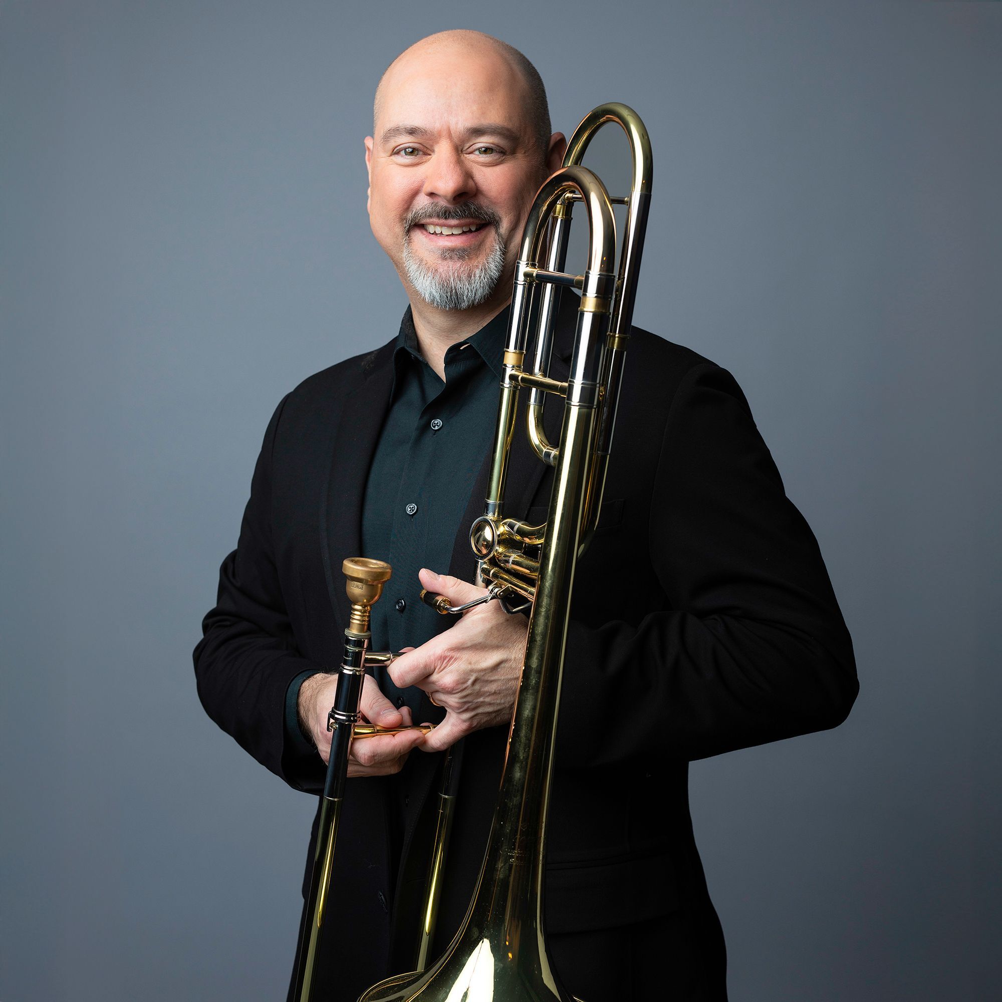 Stephen Lange headshot with trombone