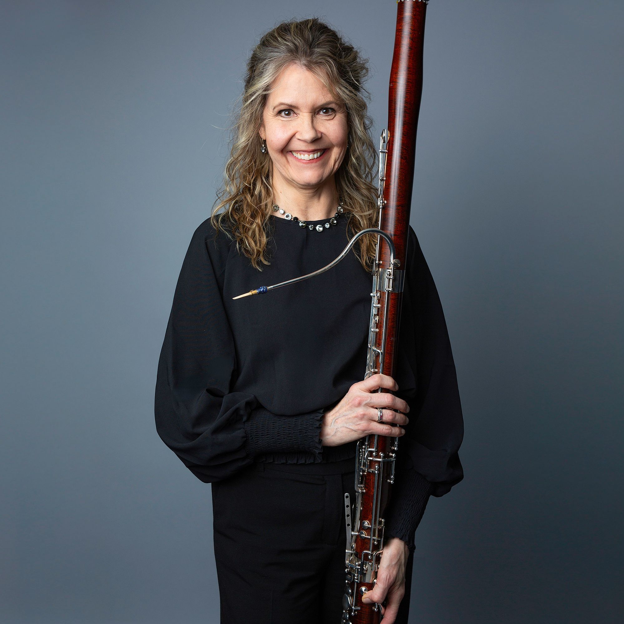 Suzanne Nelsen headshot with bassoon
