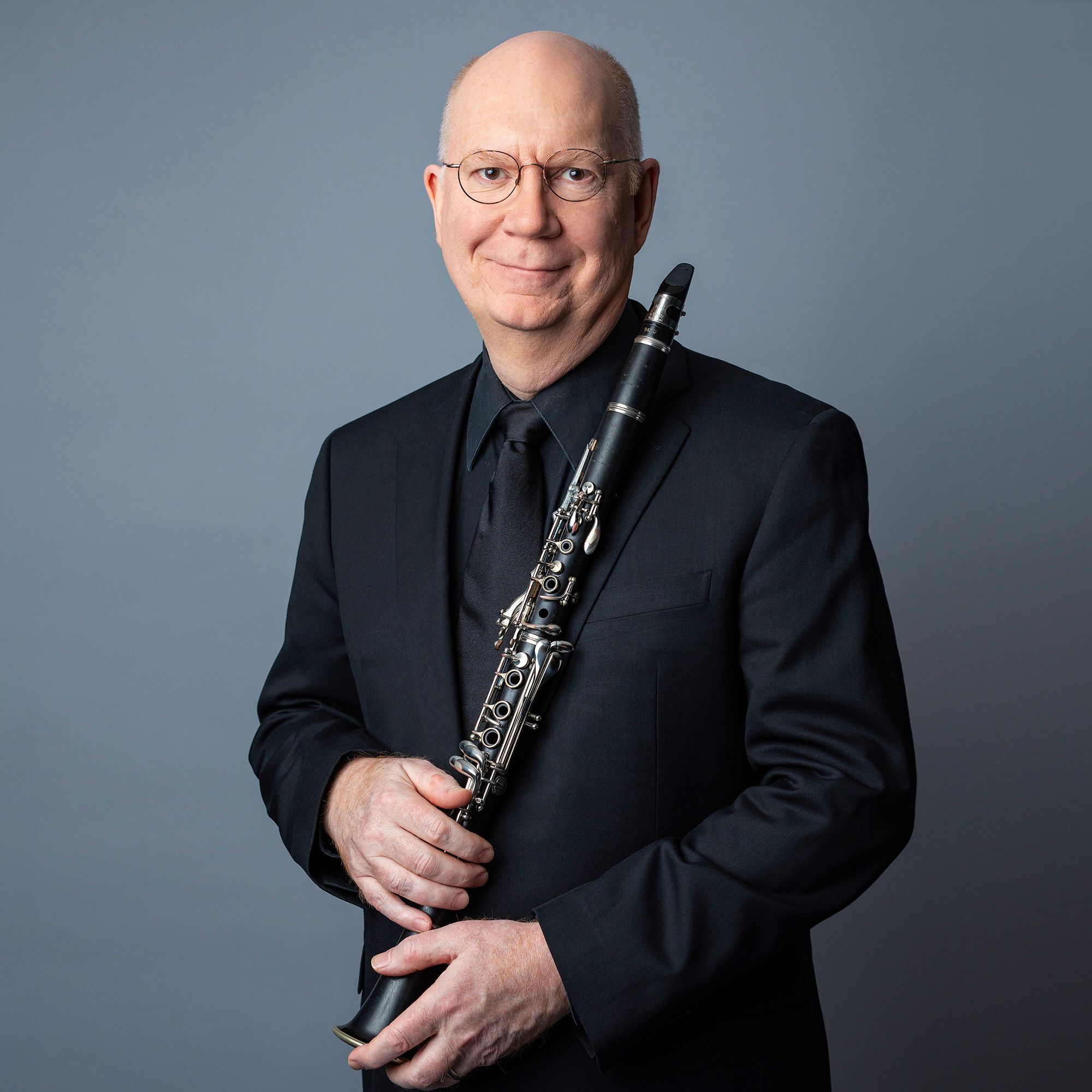 Thomas Martin headshot with clarinet