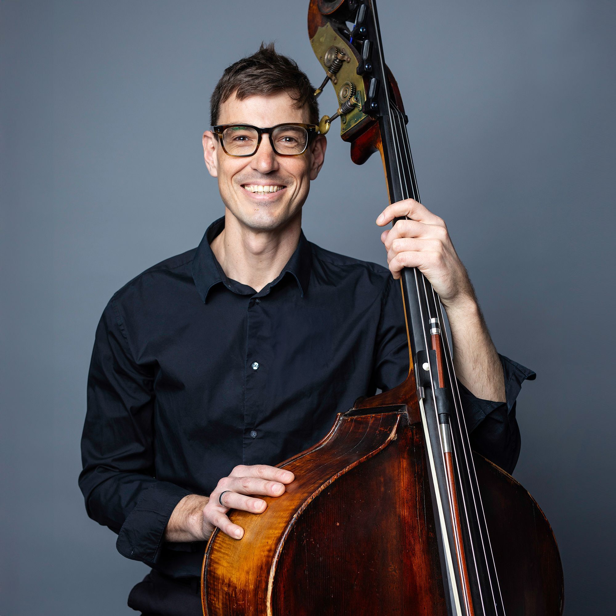 Thomas Van Dyck headshot with bass