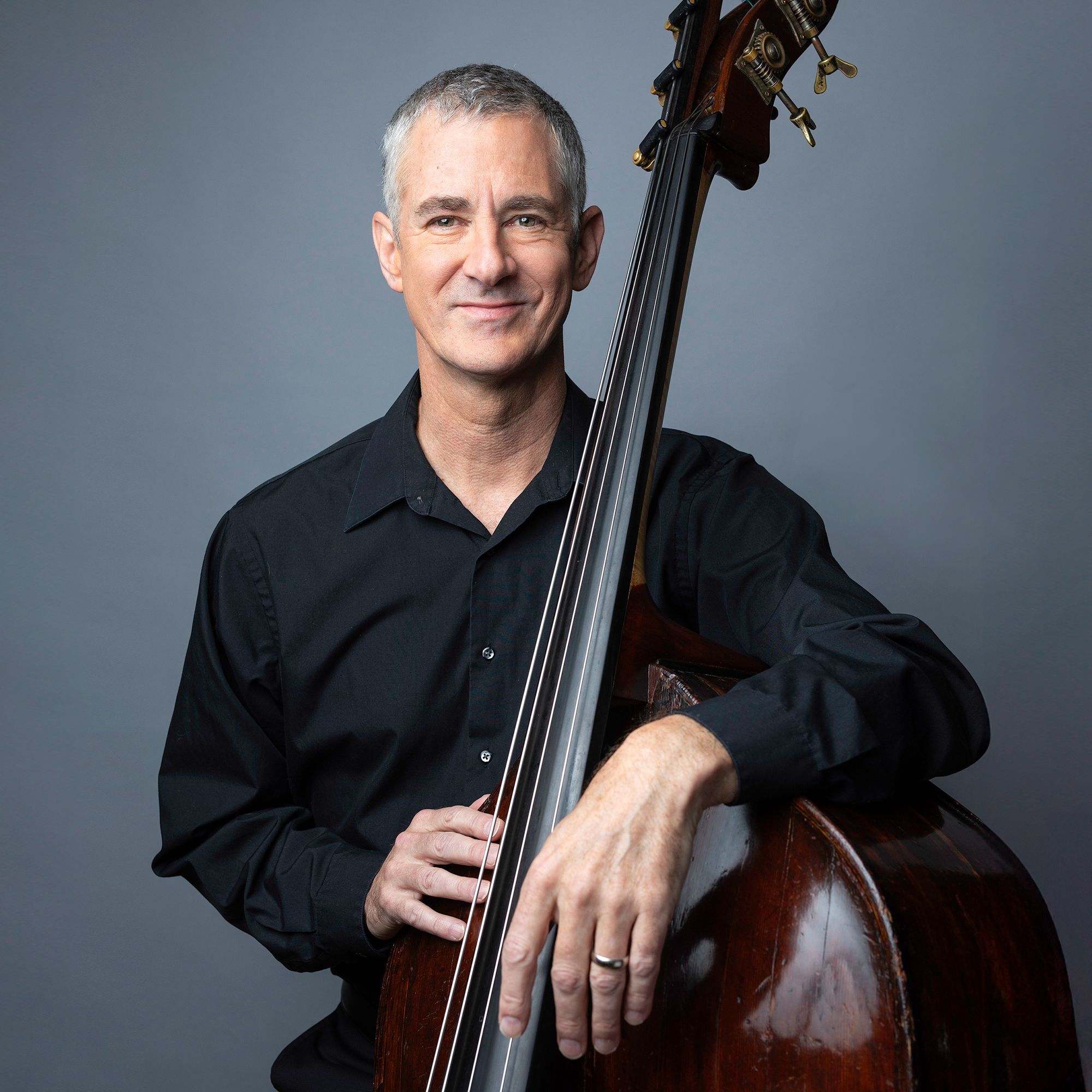 Todd Seeber headshot with bass