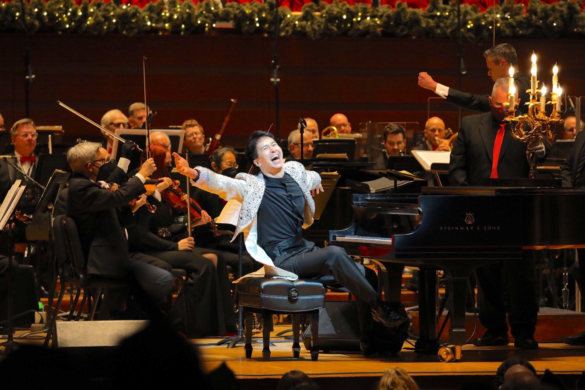 Charlie Albright sitting at the piano and smiling at the audience