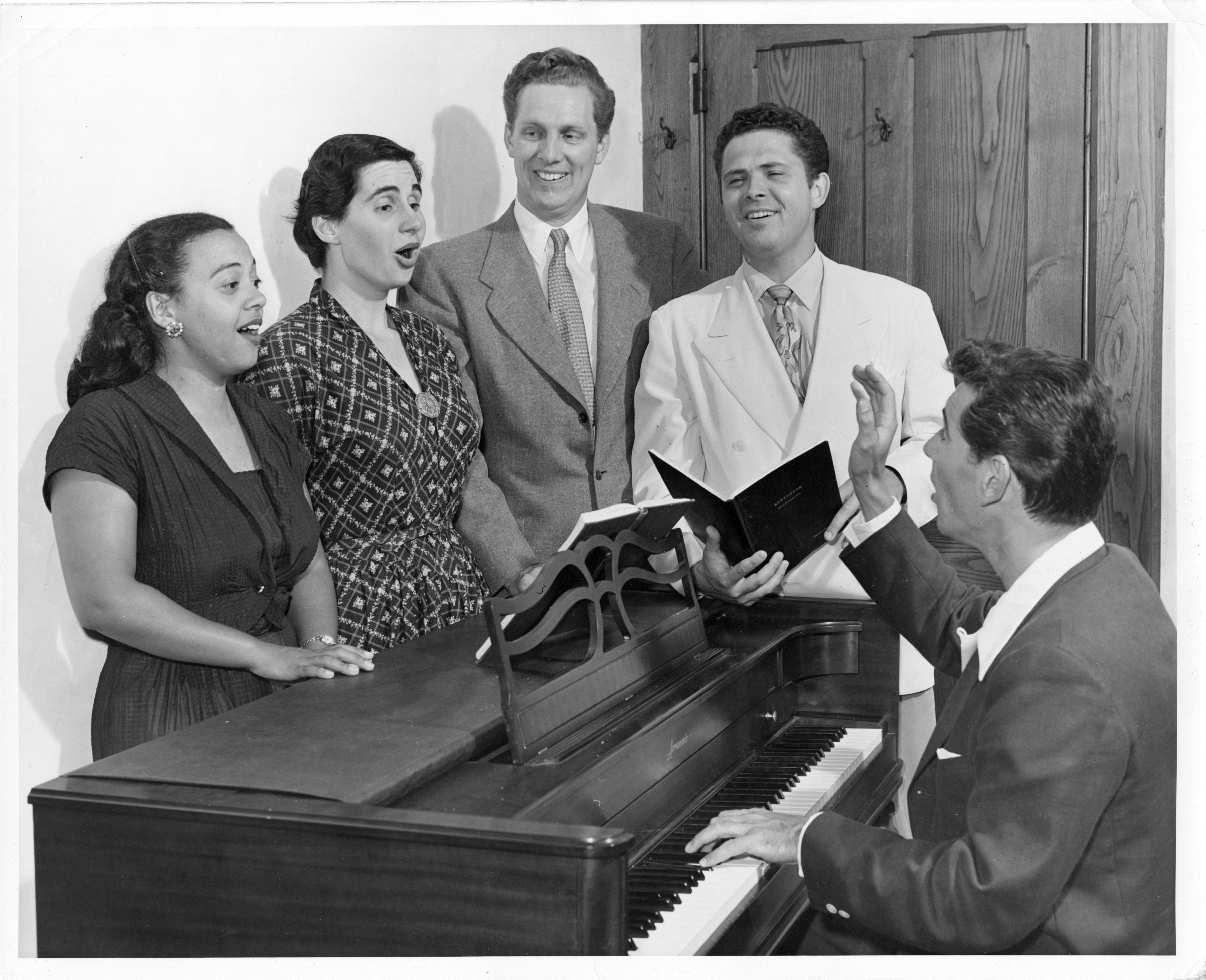 Leonard Bernstein at piano, rehearses with singers Adele Addison, Eunice Alberts, James Pease, and David Lloyd