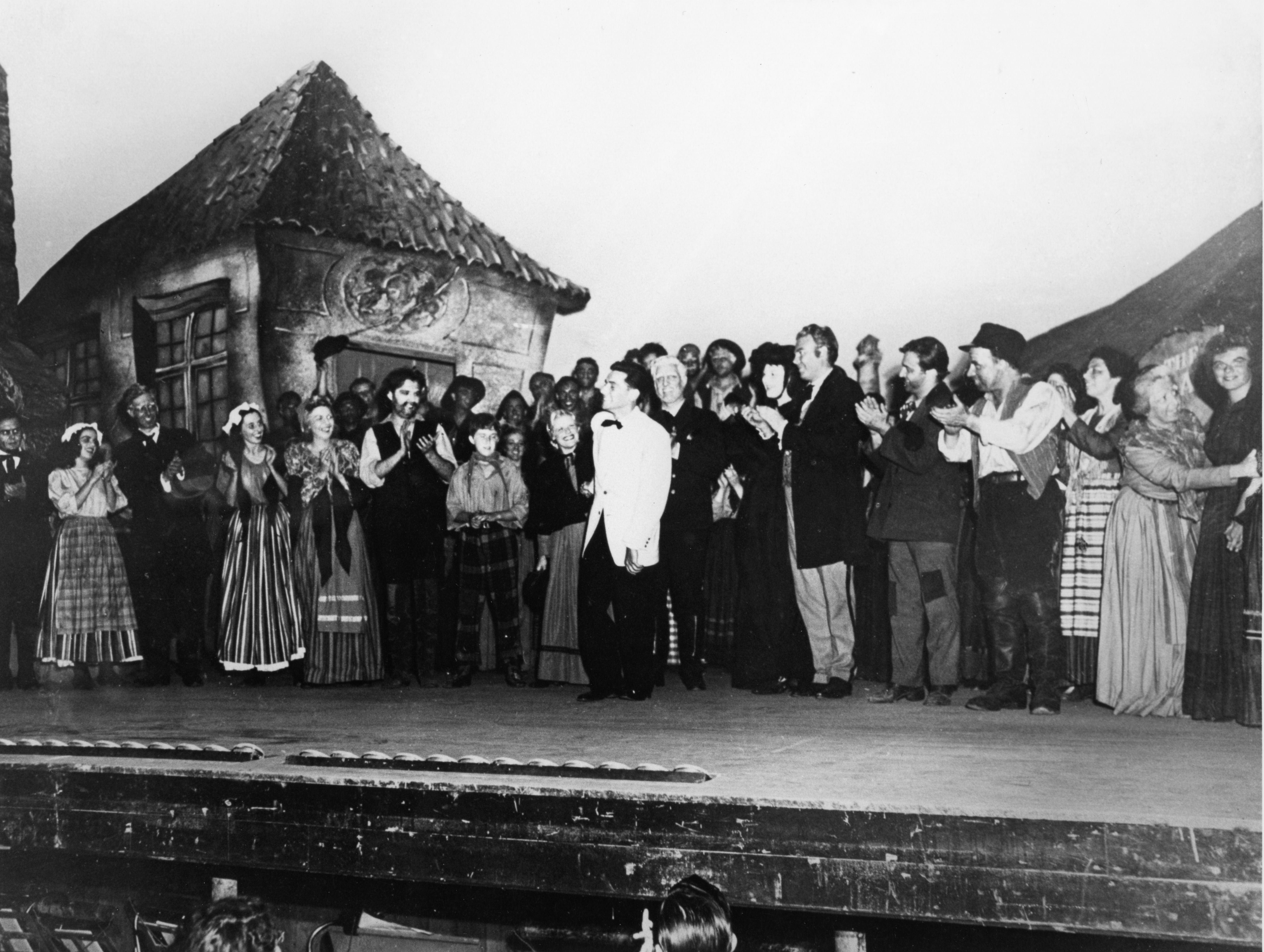 Conductor Leonard Bernstein (center, in white jacket) on the Theatre-Concert Hall stage for the curtain call of the U.S. Premiere of Britten's Peter Grimes, performed by students of the Tanglewood Music Center opera department at Tanglewood, August 1946