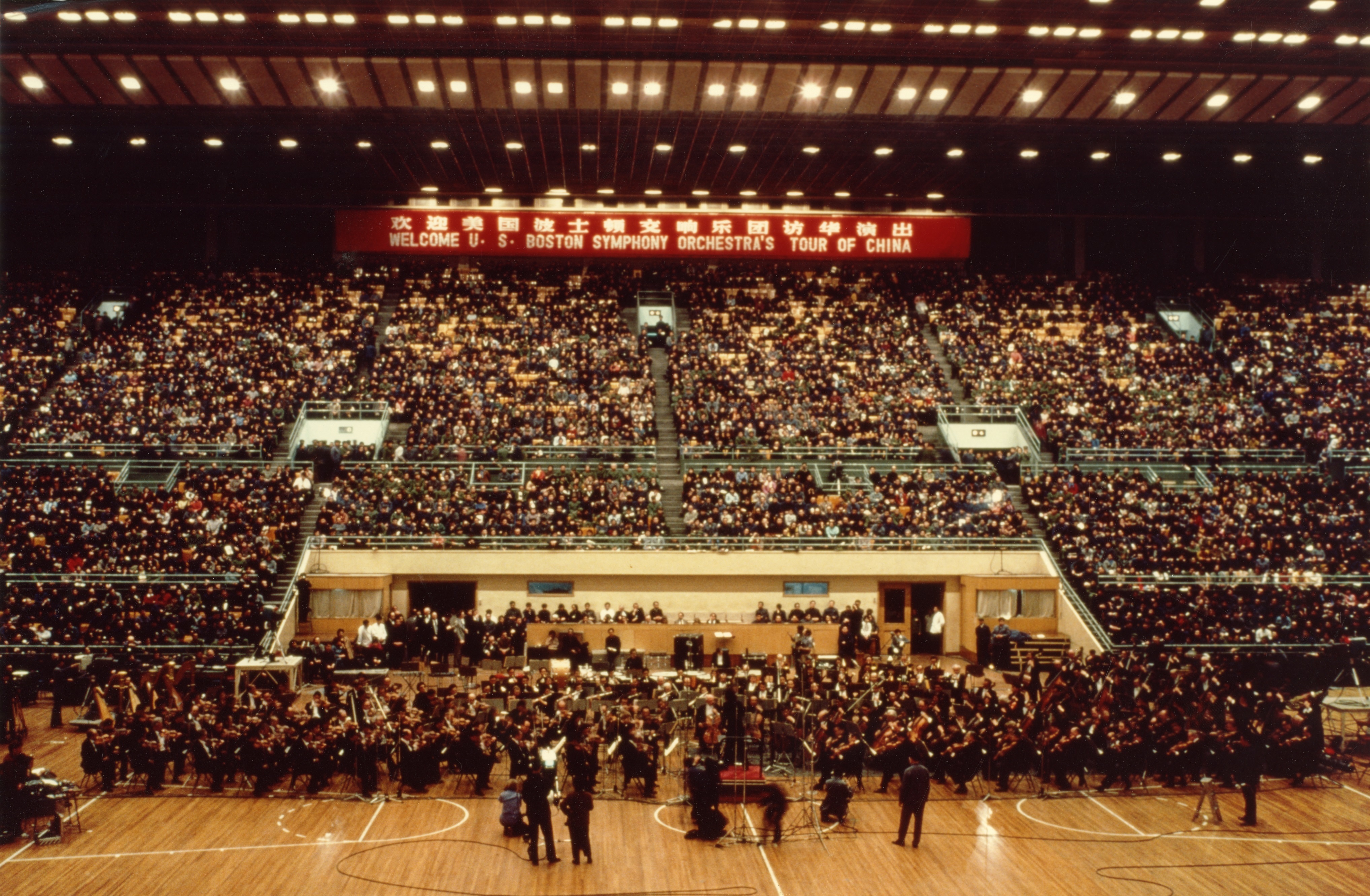 Seiji Ozawa leads members of the BSO and the Central Philharmonic Orchestra of China, March 13, 1979, at Peking's Capital Stadium