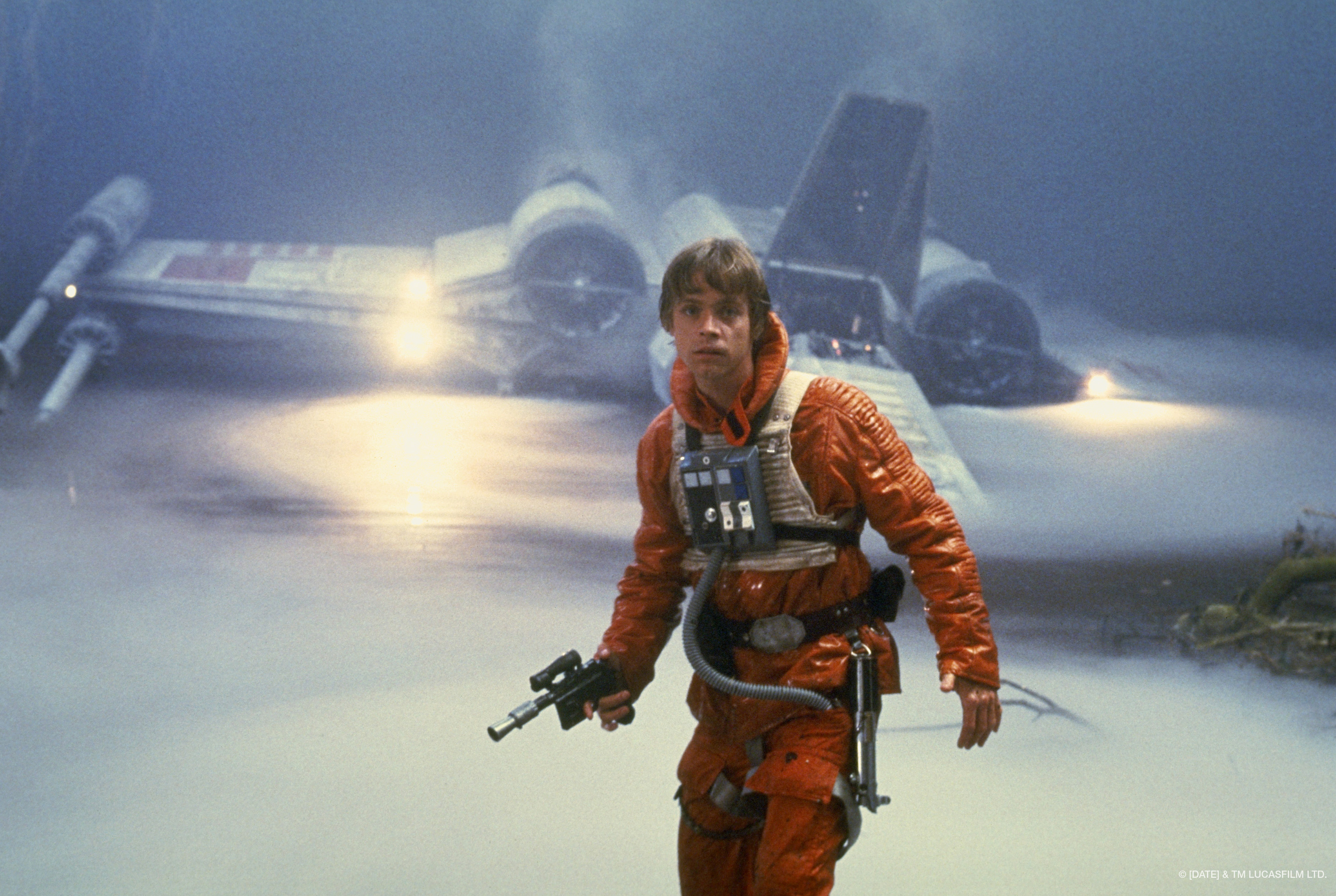 Luke Skywalker leaves his X wing, with a blaster in his hand