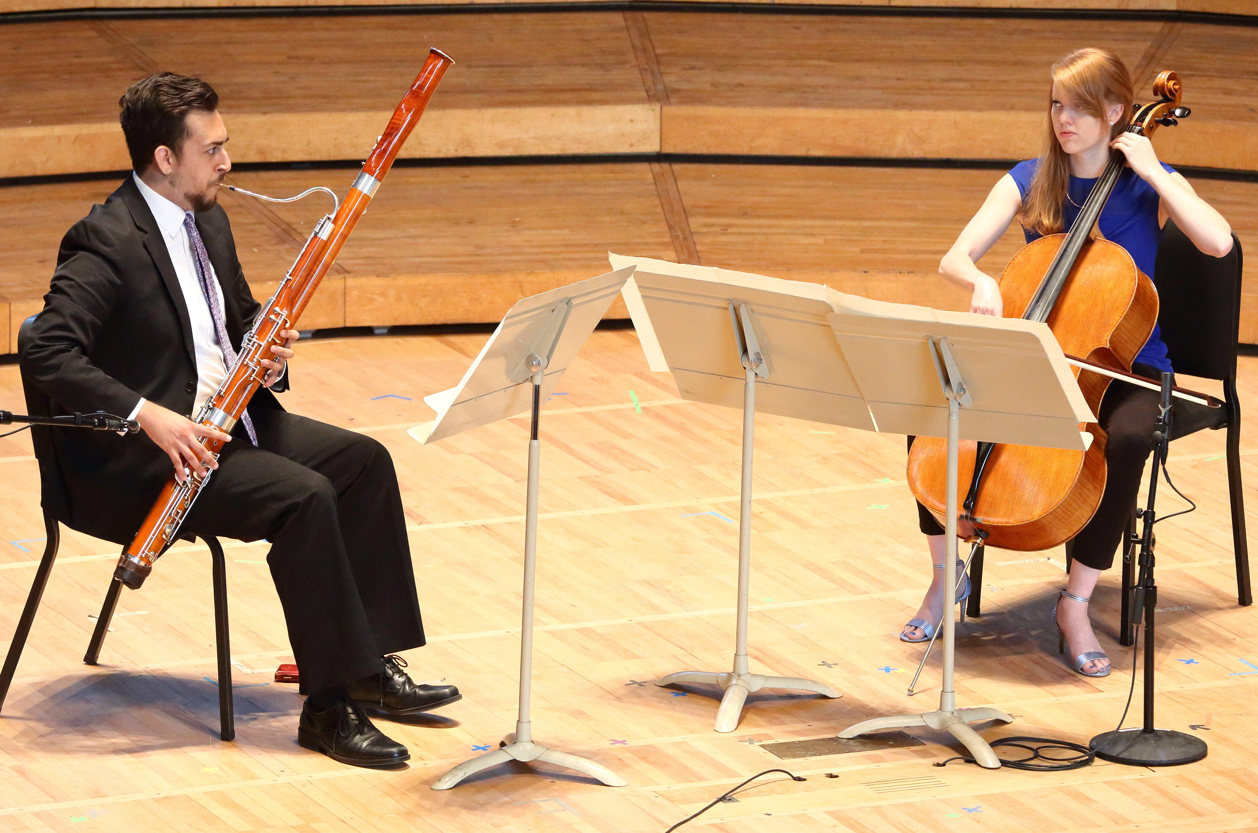 A bassoonist and a cellist perform onstage.