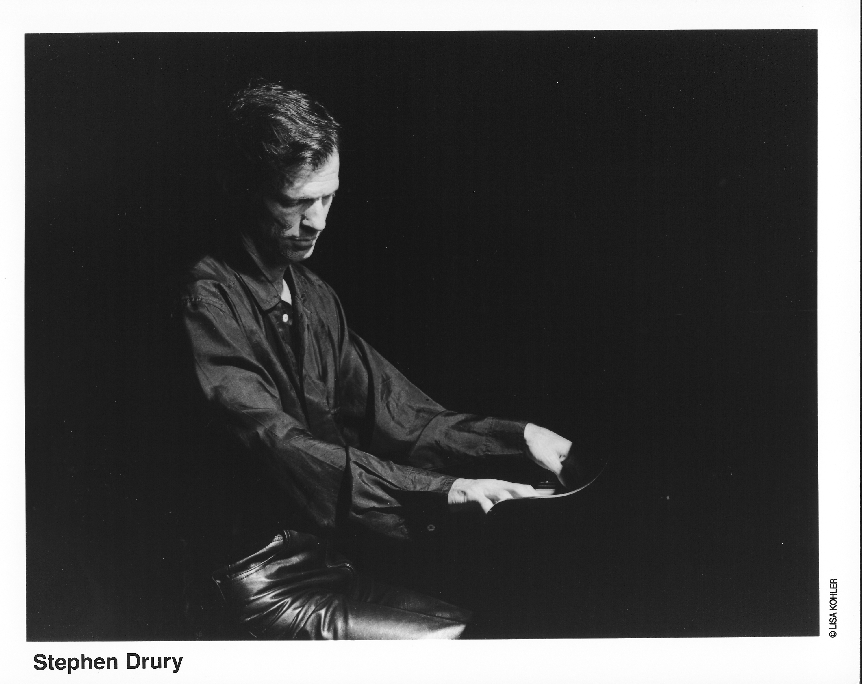 Black and white photo of Stephen Drury playing the piano.