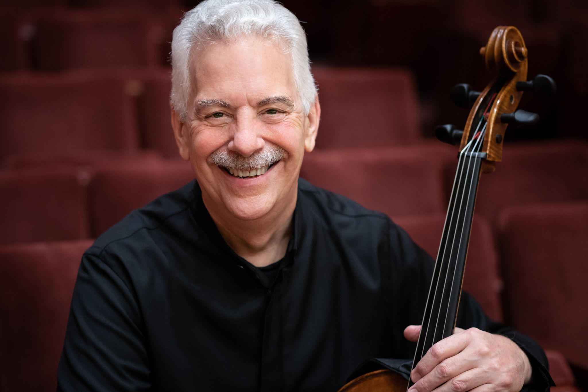 Headshot of Norman Fischer with his cello.