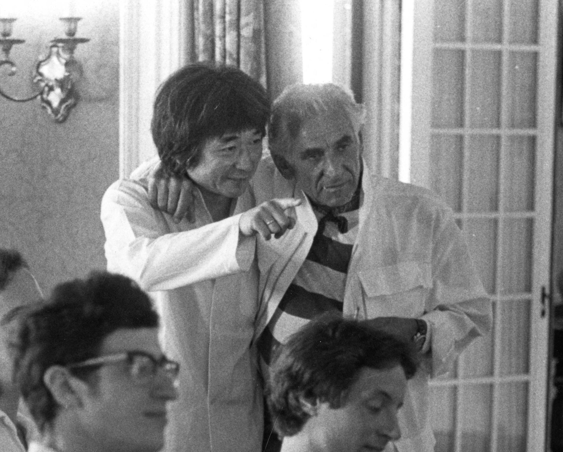 Black and white photo of Seiji Ozawa and Leonard Bernstein teaching a class of students at the Tanglewood Music Center