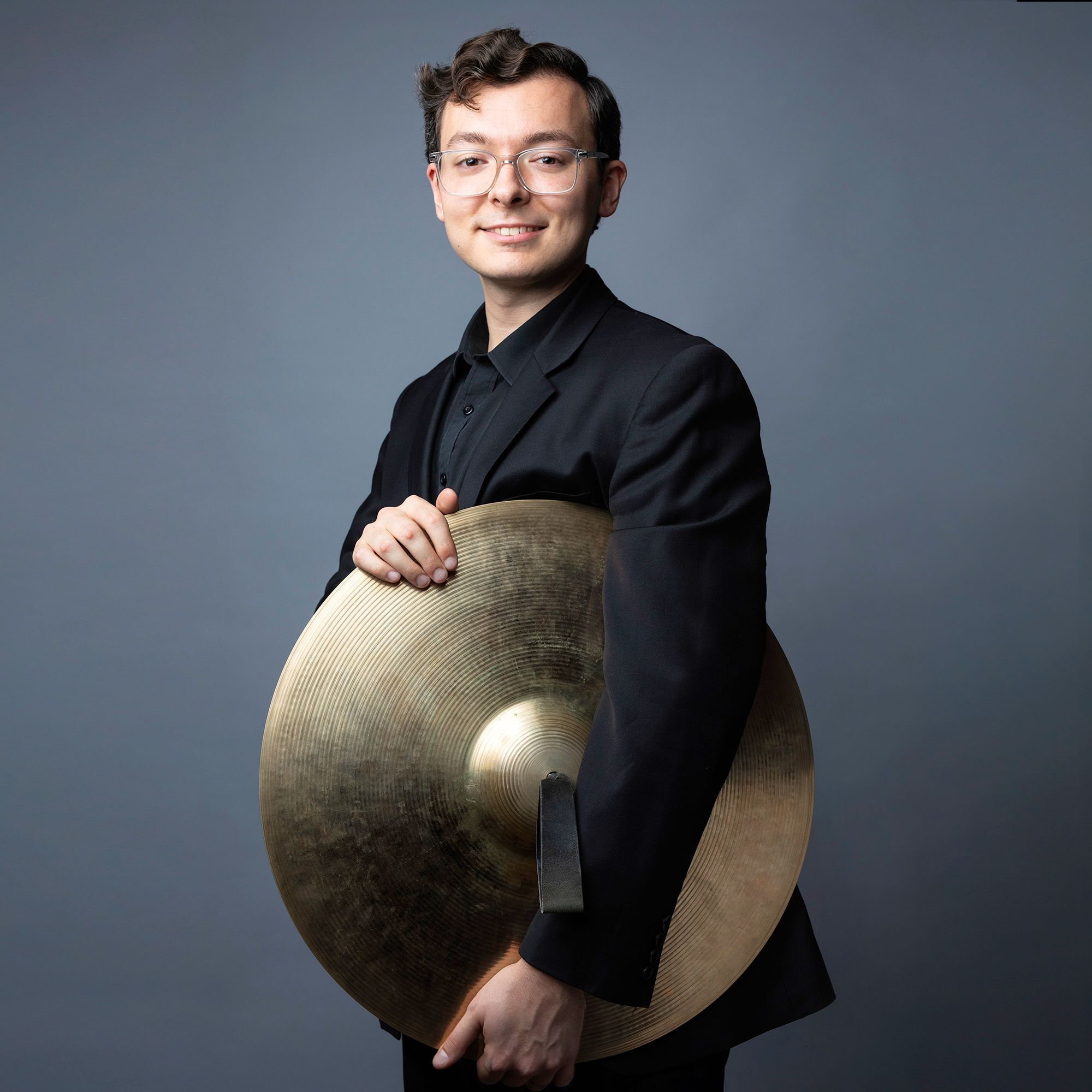 Toby Grace headshot holding cymbals