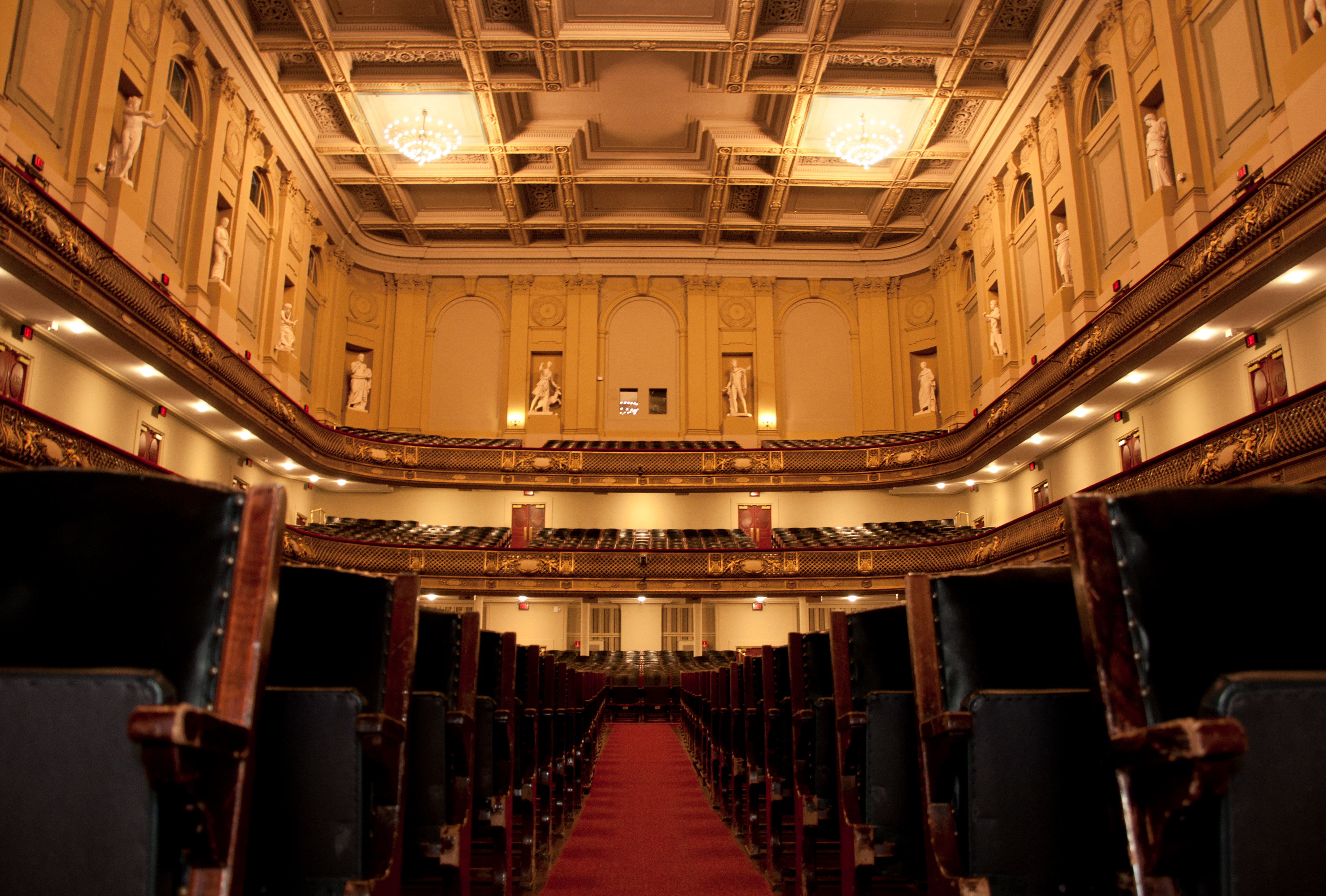 A view of the middle aisle in-between seats from the stage perspective